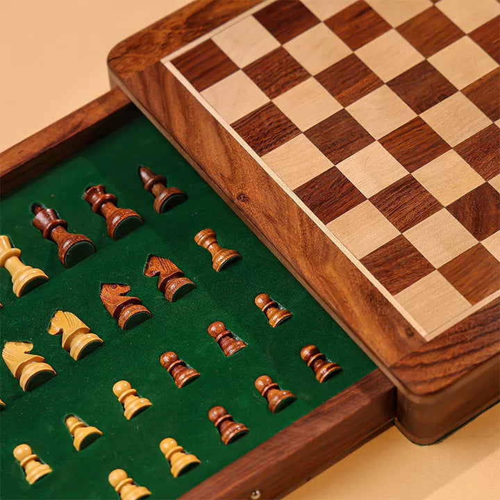 Wooden chessboard with pieces on a green felt surface