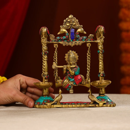 Brass Lord Krishna Fluting Idol on Swings With Hanging Panch Diya on Both Sides With Seated Peacocks Stone Work