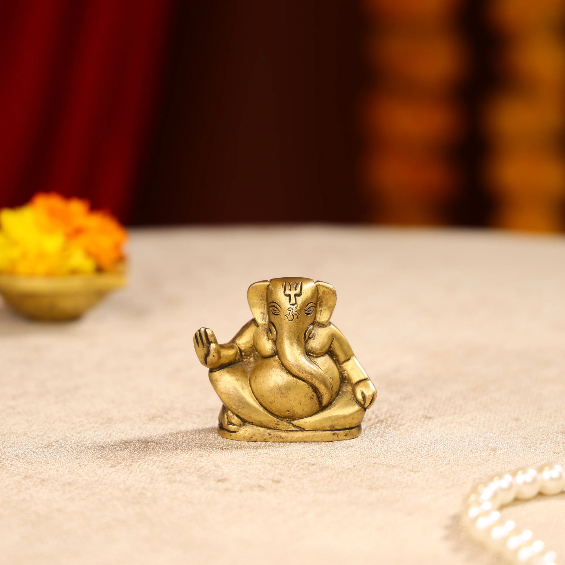 Gold Toned Lord Ganesh Brass Idol In A Sitting Posture