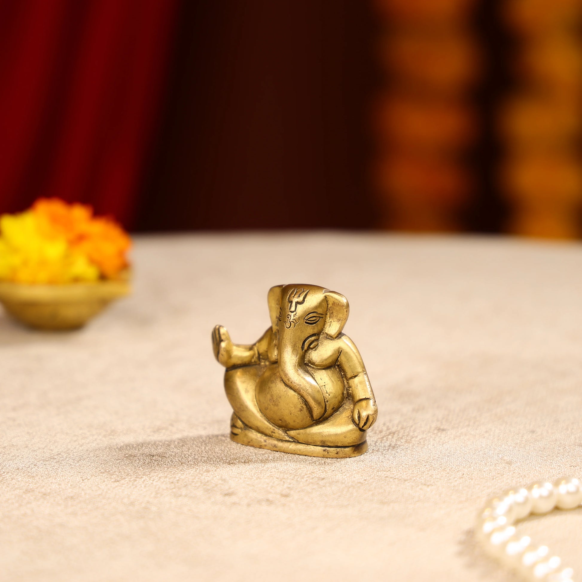 Gold Toned Lord Ganesh Brass Idol In A Sitting Posture