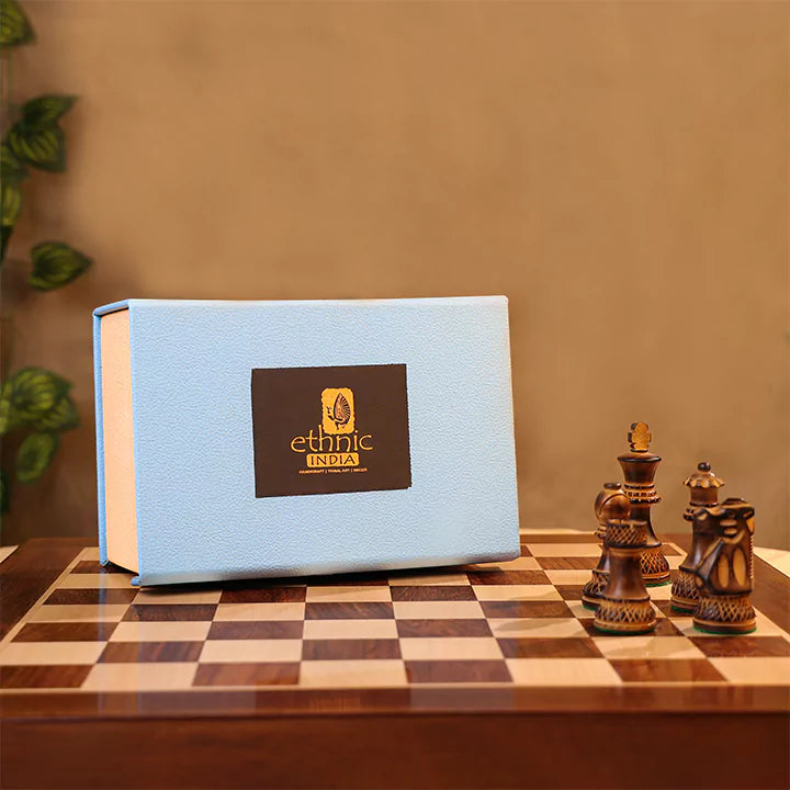 Blue book with a logo on a checkered table with wooden chess pieces.