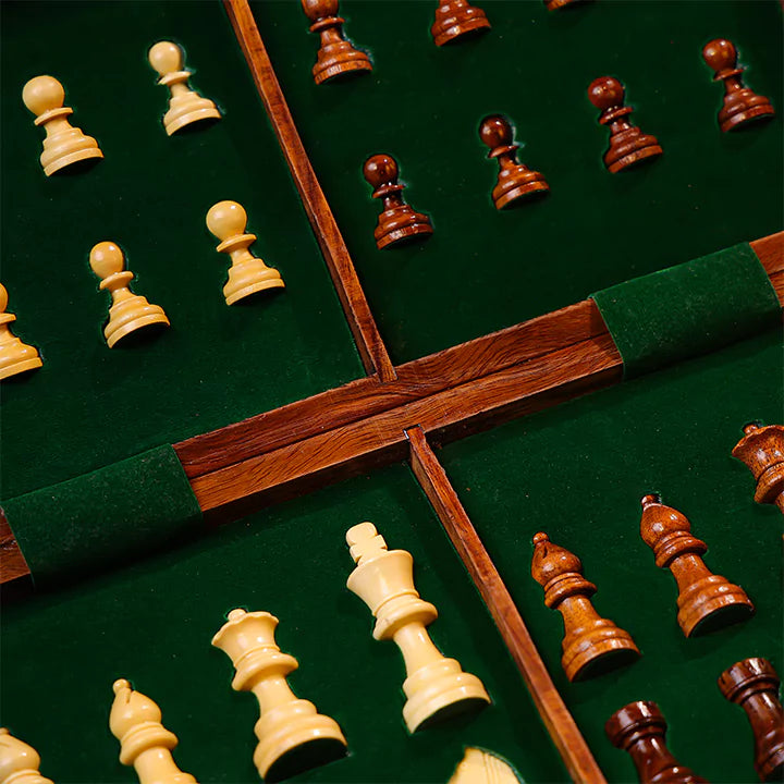 Close-up of chess pieces on a green chessboard