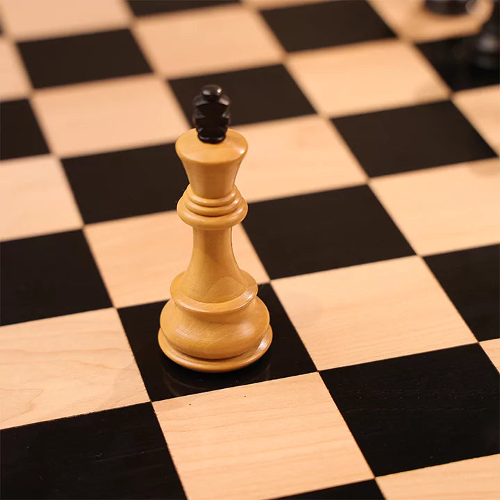 Wooden chess pieces on a checkered board