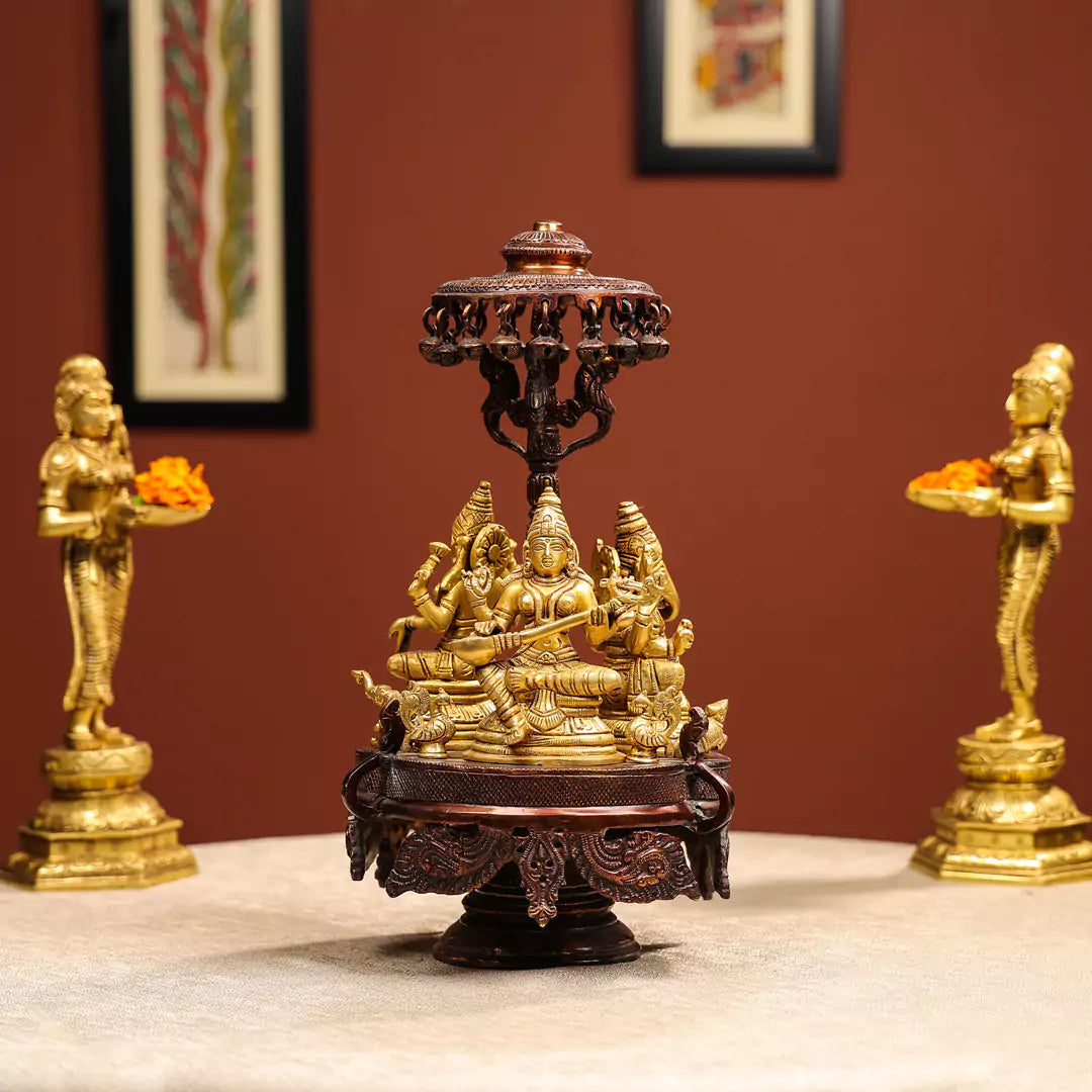 Revolving Three-Sided Idol Of Goddess Lakshmi, Goddess Saraswati And Lord Ganesh.