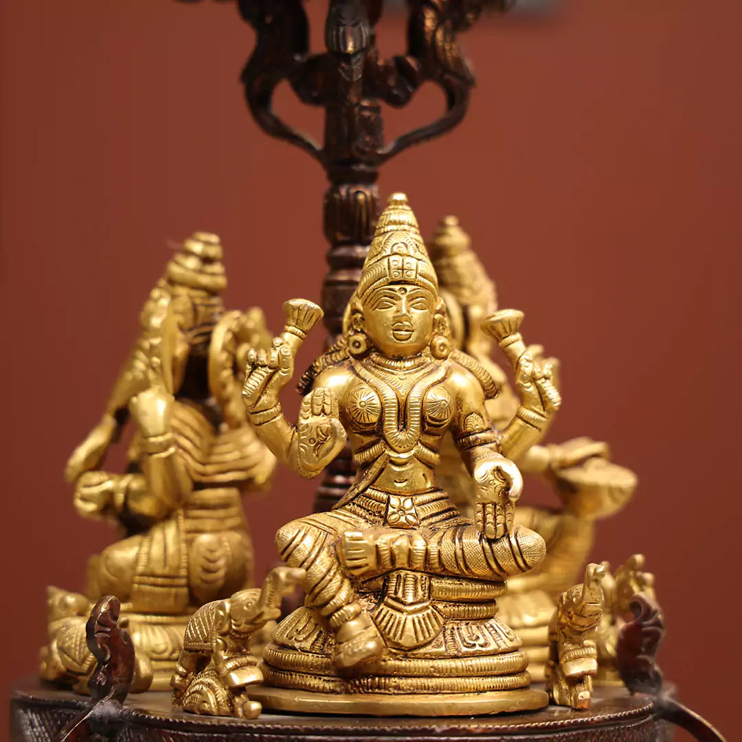 Revolving Three-Sided Idol Of Goddess Lakshmi, Goddess Saraswati And Lord Ganesh.