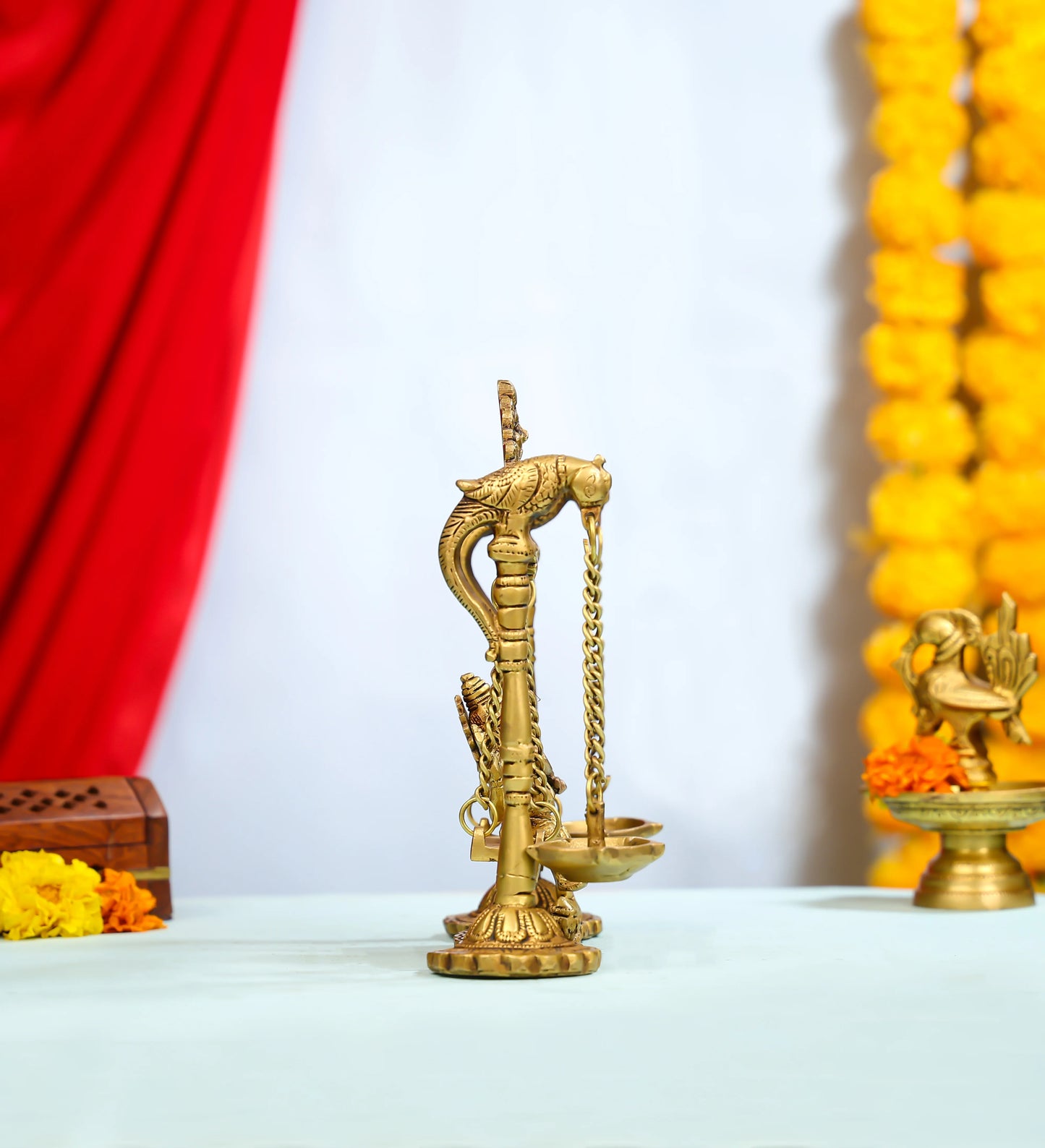 Brass Ganesha Idol On Ornate Jhula With Intricate Detailing